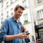 smiling man using phone in city 2021 07 22 04 59 46 utc