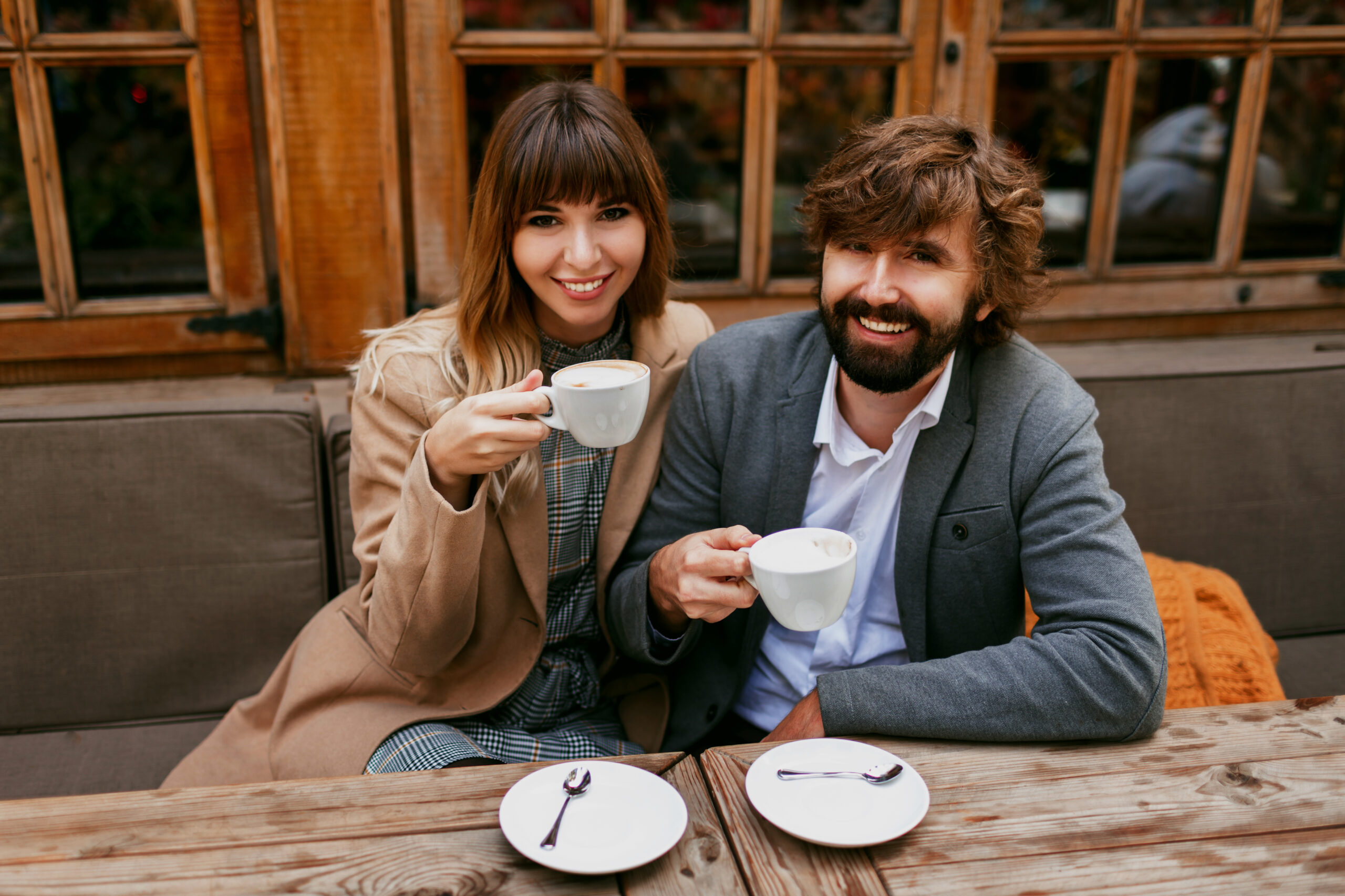 romantic moments of elegant couple in love sitting in a cafe drinking coffee having a conversation and enjoying the time spend with each other scaled