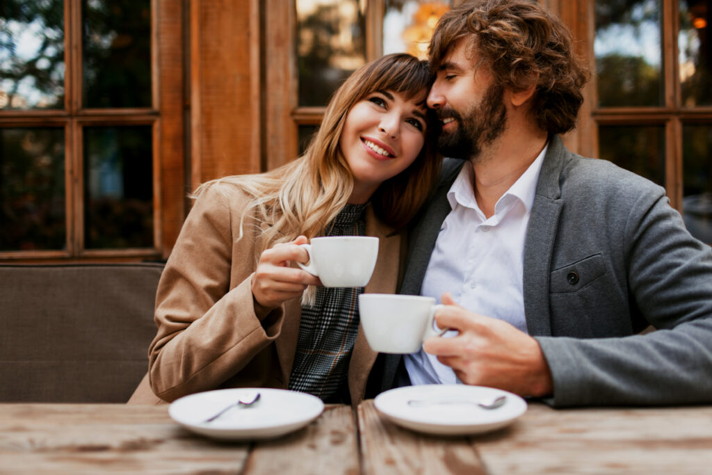 couple love sitting cafe drinking coffee having conversation enjoying time spend with each other selective focus cup